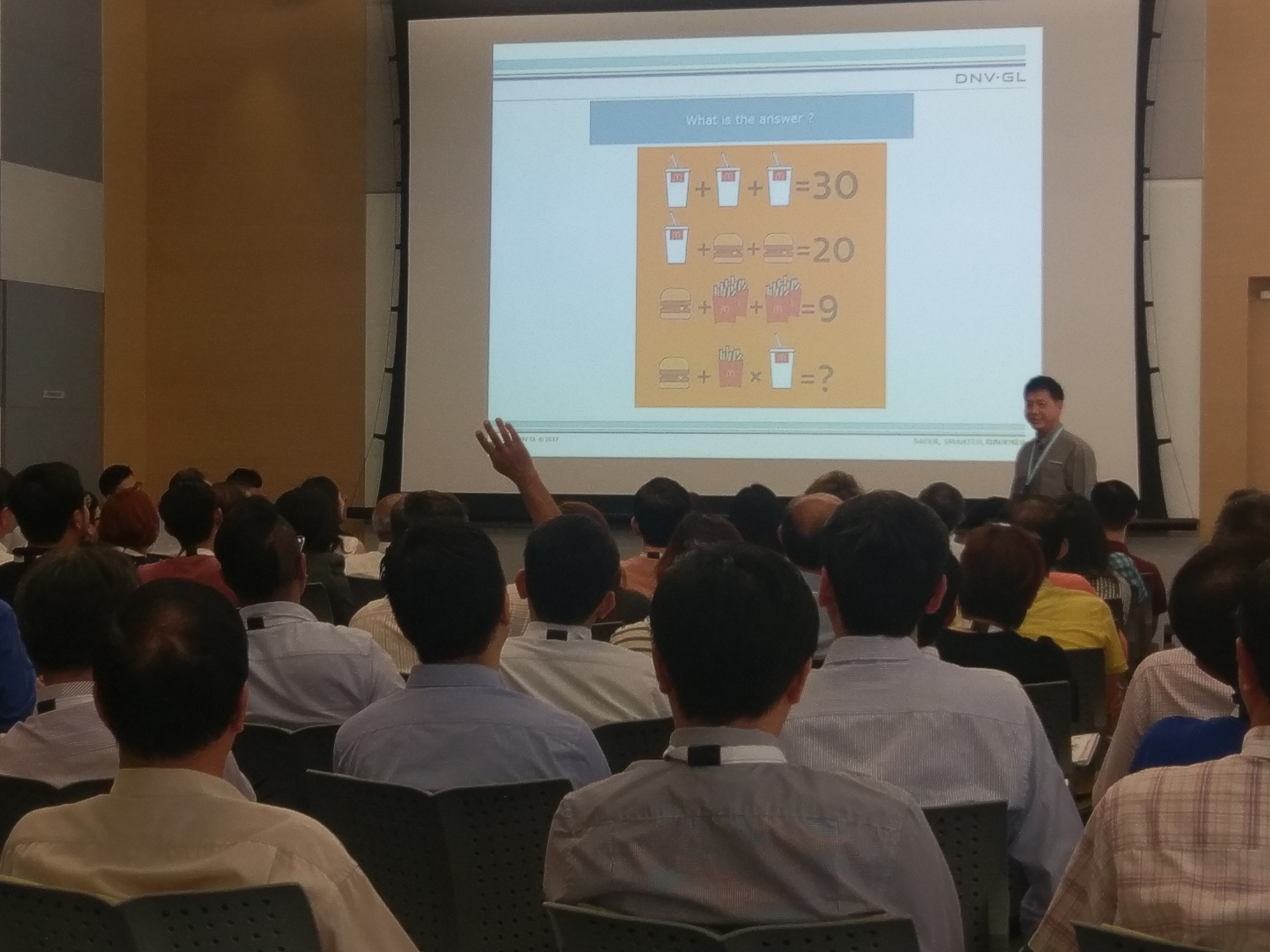 Participants waving their hands to answer Jimmy's maths questions