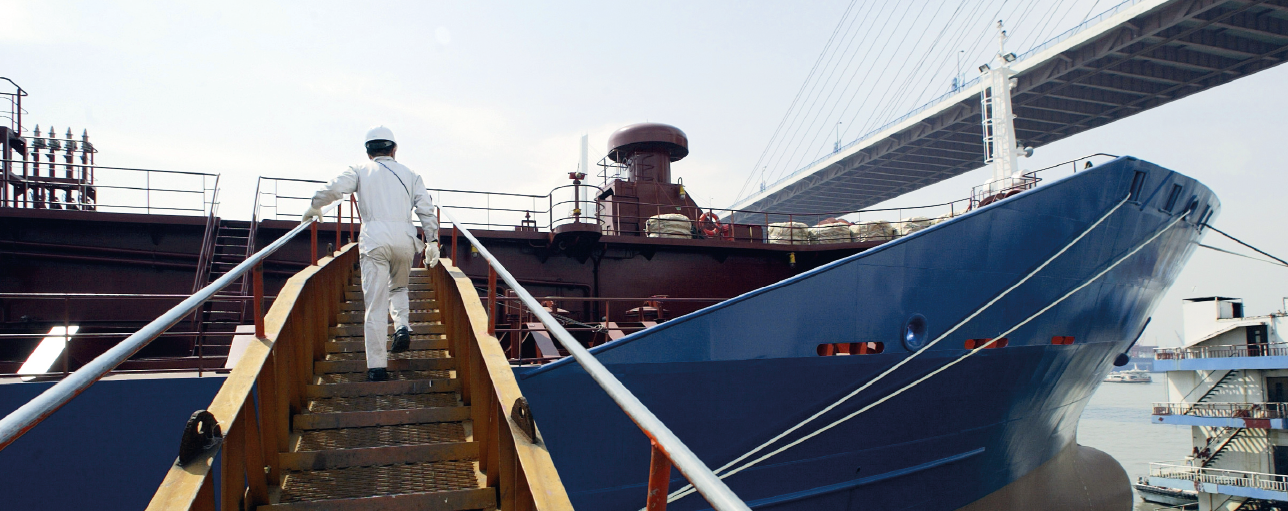 Man surveying ship at sea